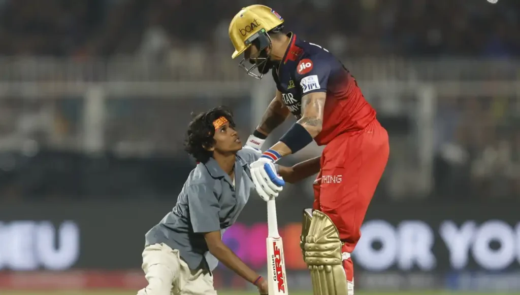 A fan dives on Virat Kohli's feet during RCB vs KKR IPL 2025