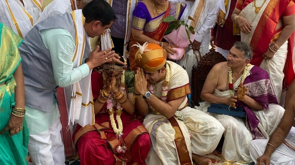Tejasvi Surya and Sivasri Skandaprasad bowing hands for blessing from BJP minister